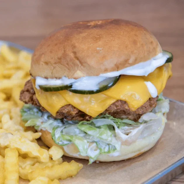 The Classic fried chicken burger with aioli, cheddar, pickled cucumbers