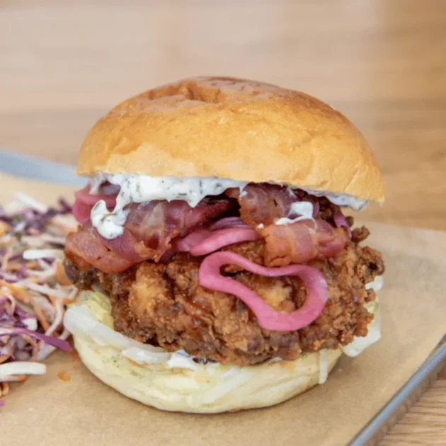 The Ranch fried chicken burger with ranch sauce, spicy honey glaze, bacon