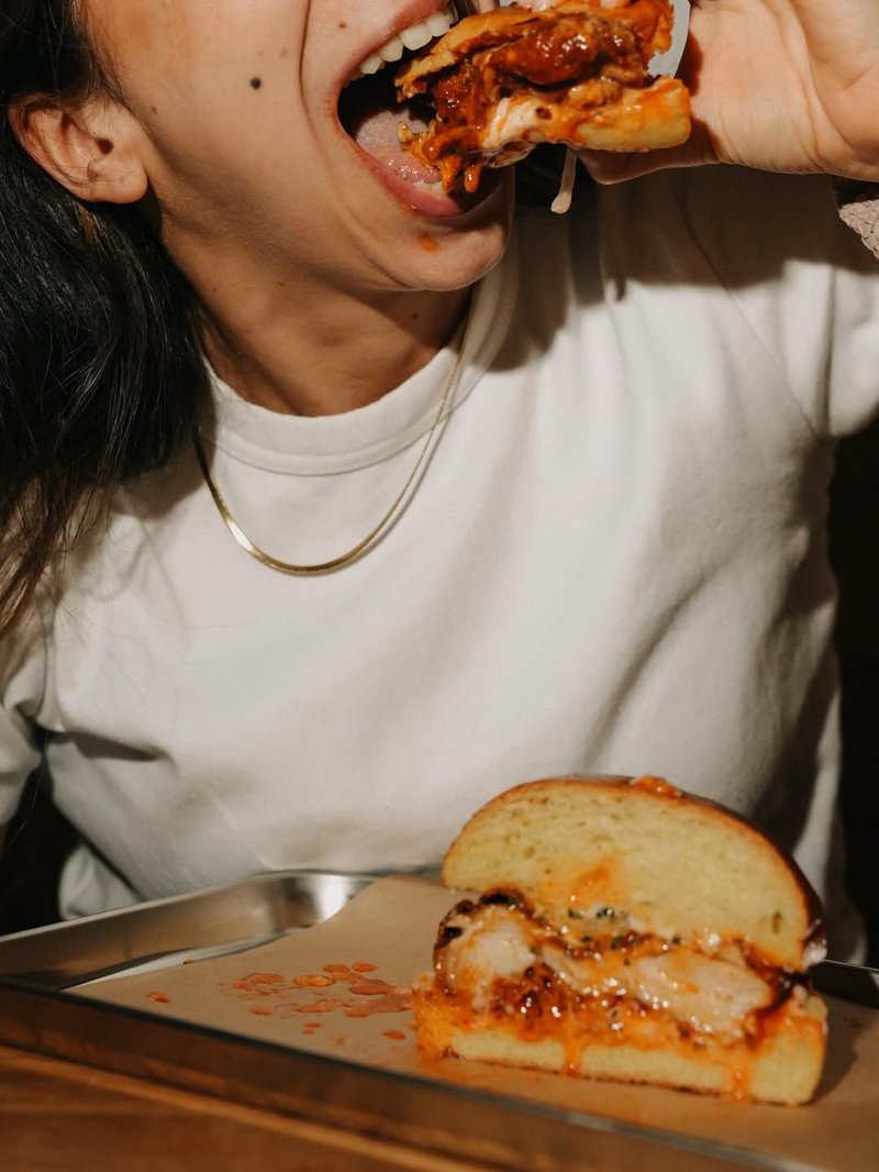 Customer enjoying a KANA burger